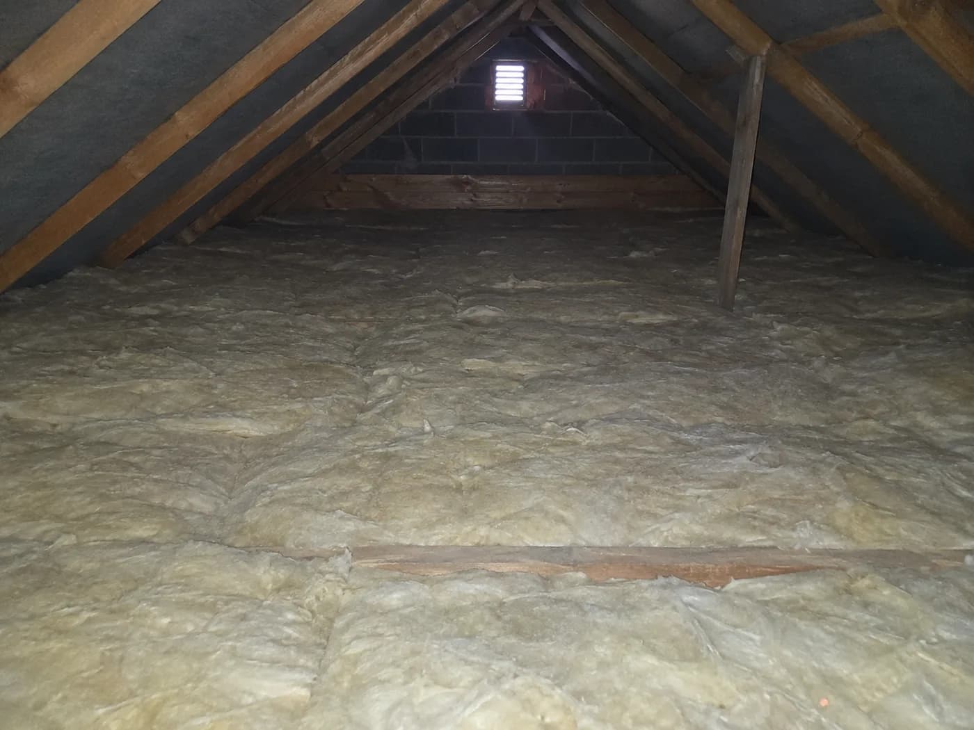 Mineral wool insulation laid between and over the joists of a domestic loft